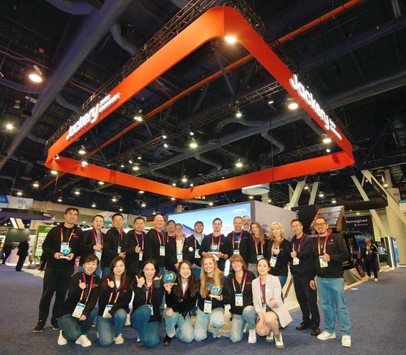 Team gathering beneath a branded exhibition booth